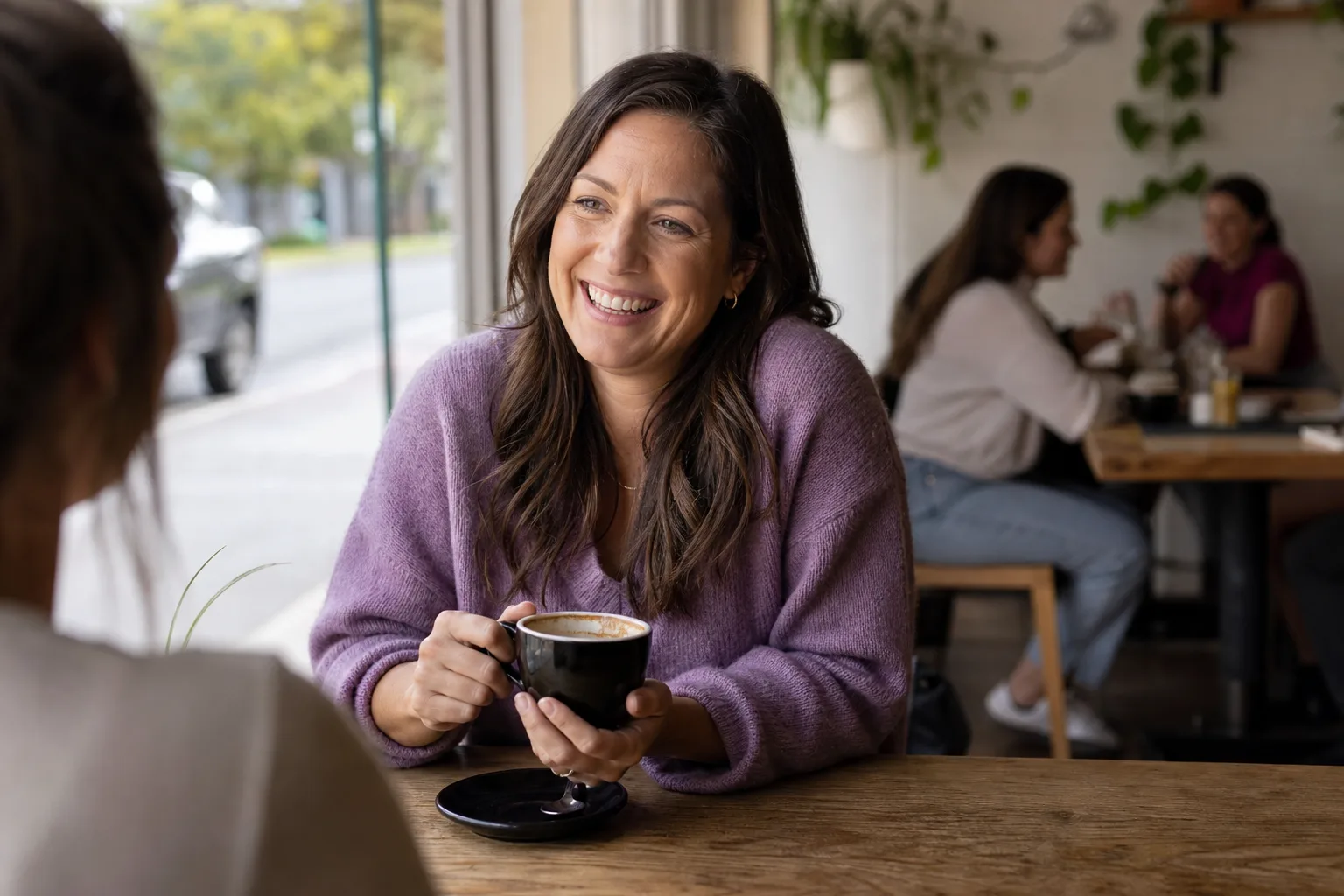 Two women chatting over coffee in Lancashire